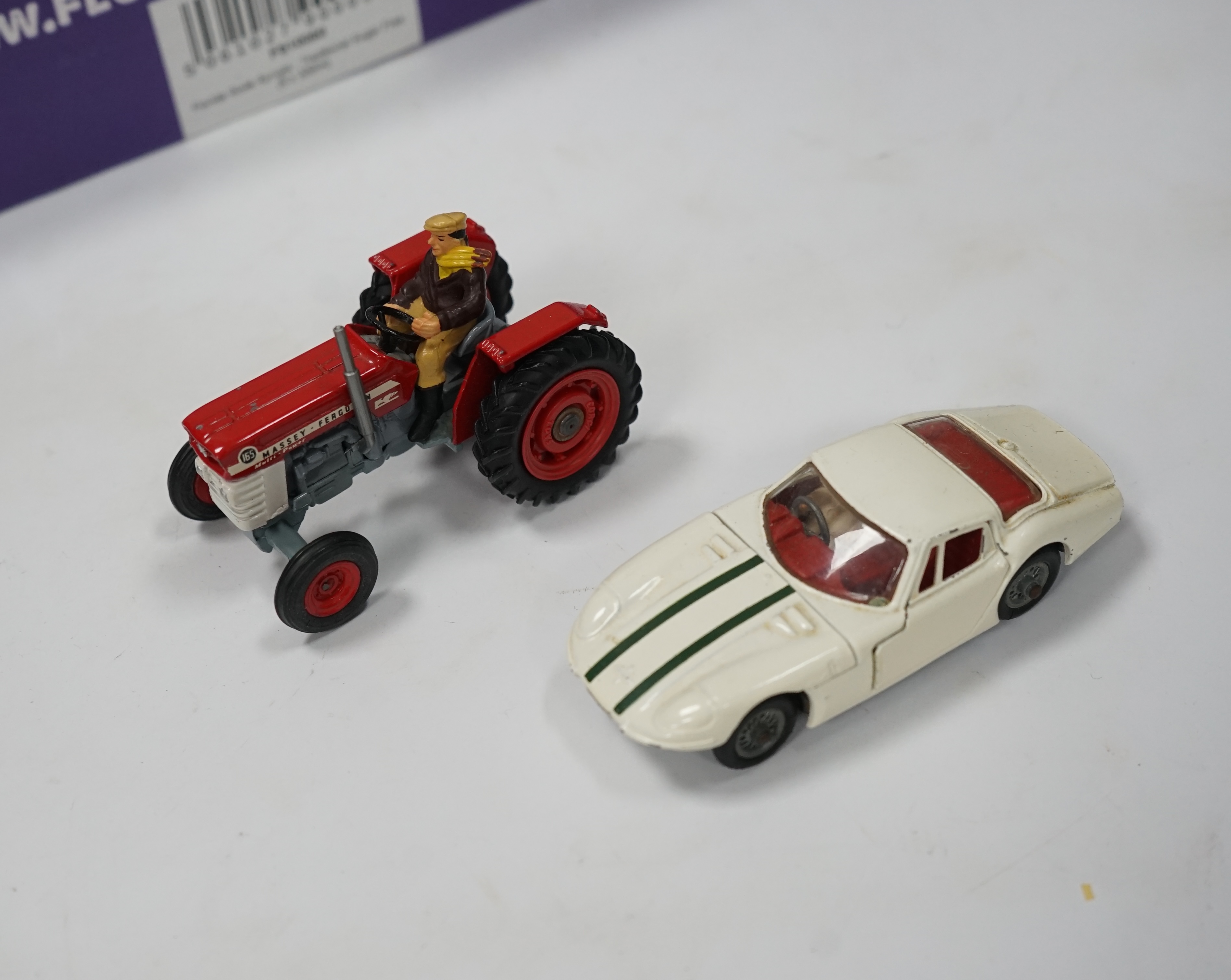 A collection of Corgi Toys and Matchbox series diecast vehicles, including a Lotus Elan 2, with ‘Tiger In My Tank’ decal, a Volvo P1800, Morris Mini Cooper, a Land Rover, a Rover 2000, a Massey Ferguson tractor shovel, e